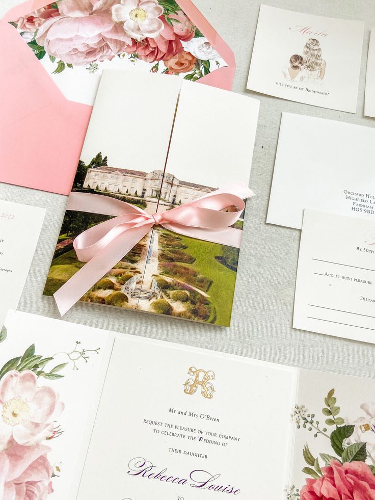 the wedding stationery is laid out on top of each other