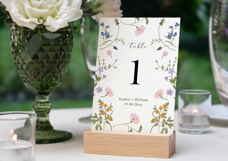 a table with flowers and candles on it