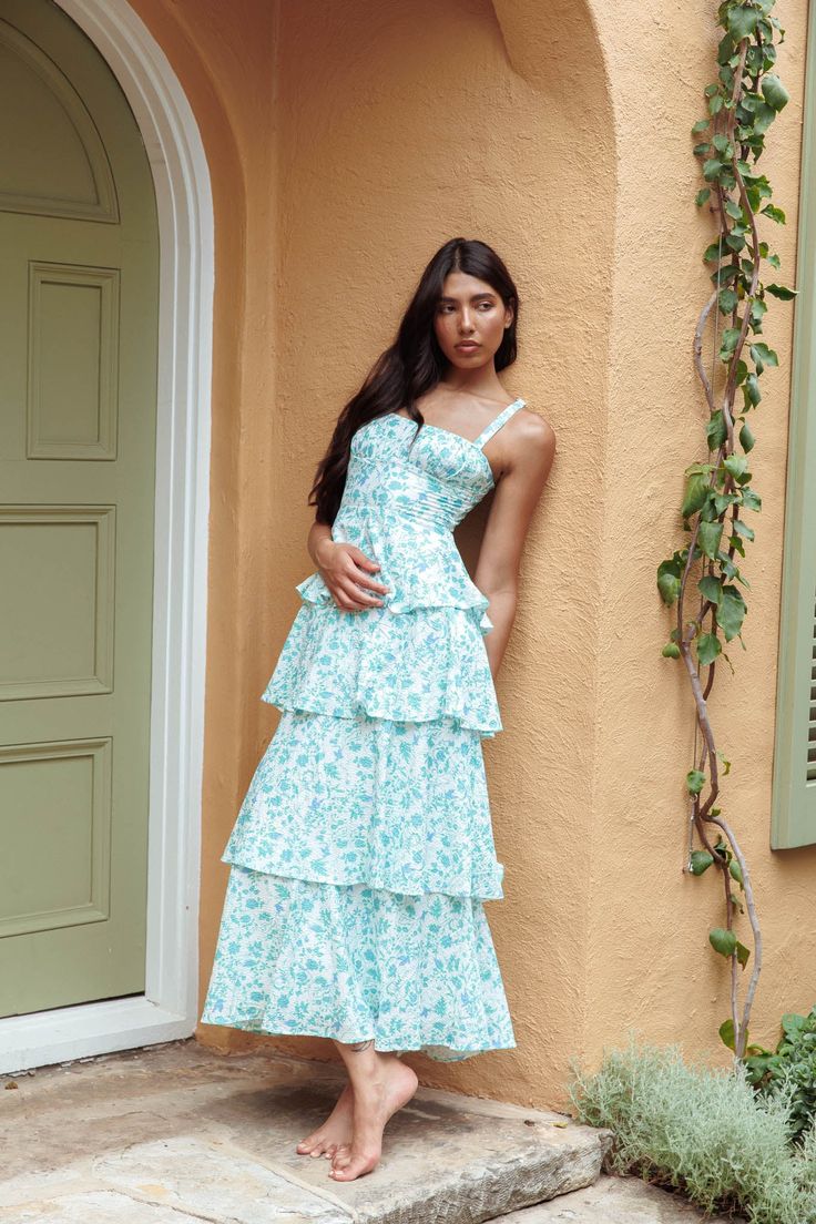 Floral green midi dress Lined Gathering in bust Tiered layers in skirt Tied. bow back Zipper in back Length: 54.8" You'll feel like running through fields of lavender in our gorgeous Provence Bloom midi dress. Perfect for a wedding or high tea birthday with your besties. Team it with white kitten heels and a clutch for a stunning look that will have everyone asking. "Where did you get your dress?!" MODEL INFO Model is wearing size XS Height: 5'7" Bust: 31.5" Waist: 23.5" Hips: 30" CARE Hand Wash Cold. Do Not Iron. MATERIAL POLYESTER/SPANDEX White Kitten Heels, Midi Dress Floral, White Kitten, Purple Bridesmaids, Yellow Bridesmaids, Tiered Midi Dress, Blue Bridesmaids, Dress Satin, Date Night Dresses