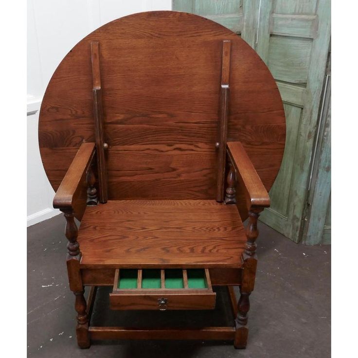 an old wooden rocking chair with green drawers