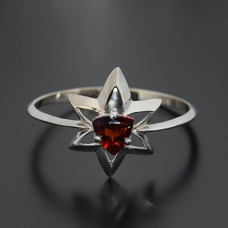 "Solitaire ring, Star ring, Garnet ring, Red stone ring, White gold ring, Gemstone ring, Triangle ring, Garnet jewelry, January birthtsone WE OFFER UNLIMITED PERIOD INSTALLMENTS PLAN This is a beautiful, stunning, feminine ring that works well for all occasions, styles, and ages. You will love it! Ring information Main stone: Garnet Approximate size: 5*5*5mm Metal type: Gold Metal stamp: 14k solid gold Customization / Replacements It's easy to create jewelry that's perfect for you. Change the ma Red Garnet Solitaire Birthstone Ring, Star Ring Engagement, Red Garnet Ring For Gift, Elegant Garnet Crystal Ring, Unique Silver Garnet Rings, Silver Garnet Solitaire Ring, Red Stone Ring, Triangle Ring, Sterling Silver Promise Rings