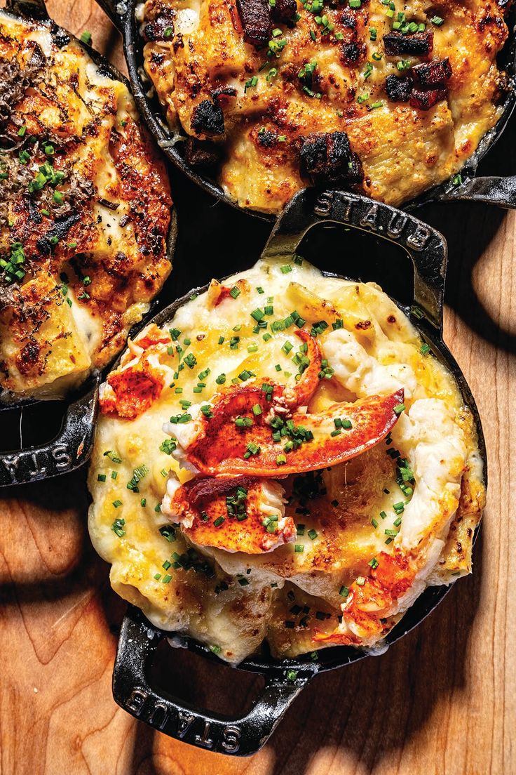 three cast iron skillets filled with different types of food