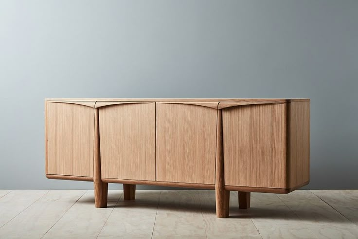 the sideboard is made out of wood and has three doors on one side, two drawers on the other