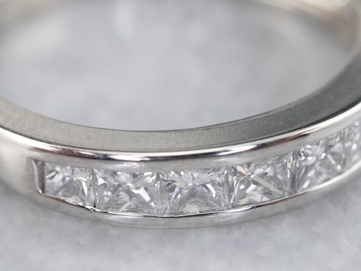 a wedding band with princess cut diamonds on it