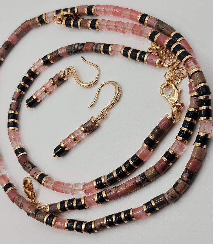 Handmade Natural Rhodonite, black Agate and Watermelon Tourmaline jewelry set. Set of bracelet and earrings.  Rhodonite can be used to calm you during traumatic times. Watermelon Tourmaline will balance your male and female energies. Diameter tube beads 4mm. Set comes in a gift box ready for gifting. You might also like https://www.etsy.com/uk/shop/LoveIuliia?ref=l2-about-shopname§ion_id=42402163 Thank you so much for visiting my shop Iuliia xx Tourmaline Jewelry With Natural Stones For Gifts, Rose Gold Gemstone Beads Jewelry For Gift, Rose Gold Jewelry With Gemstone Beads For Gift, Tourmaline Jewelry With Round Beads As Gift, Tourmaline Natural Stones Bracelets As Gift, Adjustable Tourmaline Gemstone Beads Jewelry, Dangle Tourmaline Jewelry As Gift, Tourmaline Dangle Jewelry For Gifts, Handmade Tourmaline Bracelet