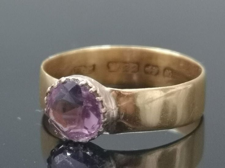 A 19th century antique ring in 22 Karat Yellow Gold with Victorian claw setting with Amethyst stone. Ring fit size: finger to top of stone measures 52 mm, UK ring size :M (circular), 4 gms. total weight including gemstone. The satin interior of the presentation case bears the retailer's mark 'Charig LTD, Court Jewellers, 38 Old Bond Street, London, W'. Birmingham mark date 1897. IMPORTANT!  N.B. - ITEMS ARE SOLD AS SEEN. WE ONLY SELL AUTHENTIC ANTIQUES AND VINTAGES. As we are selling ANTIQUES and VINTAGE items, Please EXAMINE PHOTOS CAREFULLY since they are binding and a supplement to the word description. If description is not properly noted, it does not qualify as 'item not as described' as it all shows in the pictures. Item ordered will be exactly the same as in pictures. Items are pres Bond Street London, Antique Rings Victorian, Victorian Ring, Victorian Rings, Amethyst Gem, Yellow Gold Setting, Purple Band, Selling Antiques, Bond Street