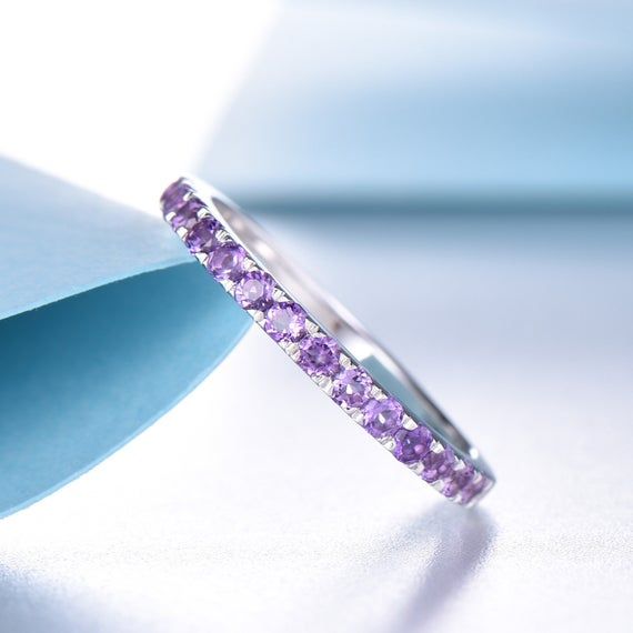 This is an amethyst ring.Stone:*Half eternity 2mm Natural amethyst.Custom Order<><><><><><><><><><><><><><><>*The main stone can be other gemstones you can imagine,any birthstone can be made.Please contact me if you need this service.*Any size*I can also design the matching band.Other<><><><><><><><><><><><><><><>*Rush Amethyst Eternity Ring, Elegant Purple Amethyst Ring With Round Band, Purple Half Eternity Ring For Anniversary, Purple Amethyst Stackable Wedding Rings, Elegant Purple Stackable Birthstone Ring, Elegant Purple Gemstone Stackable Rings, Fine Jewelry Amethyst Diamond Ring In Purple, Fine Jewelry Purple Amethyst Ring With Prong Setting, Purple Tanzanite Ring With Prong Setting