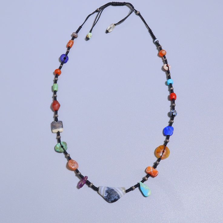 A beautiful hand crafted necklace made with ancient Lapis, turquoise, etched carnelian, sulemani agate, coral. the coral is from yemen circa 1400AD all other beads are Afghan origin circa 100AD-200BC. the necklace is made with very fine thread which feels comfy around the neck & gives a very pleasant vibe. All the beads are 100% real antiques found in excavations at different sites. they are not manufactured now or modified but were created by ancient humans by hand. literally one of a kind necklace!! Bohemian Agate Jewelry With Natural Stones, Bohemian Lapis Lazuli Jewelry With Colorful Beads, Spiritual Turquoise Necklace For Festivals, Artisan Lapis Lazuli Jewelry With Polished Beads, Bohemian Amber Beaded Necklace, Hand-strung, Bohemian Amber Beaded Hand-strung Necklace, Bohemian Amber Beads With Natural Stones, Bohemian Amber Hand-strung Beaded Necklaces, Spiritual Festival Jewelry With Gemstone Beads