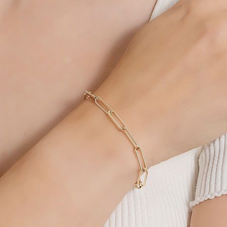 Add a trendy look to your jewelry collection by adding this Silver Reflections 14K gold over brass paperclip chain bracelet. This bracelet is crafted in 14K gold over brass, available in 7.25 inches length, has a solid paperclip chain construction and features a lobster clasp closure for a safe and comfortable wear. If you're looking for the perfect trendy chain bracelet for stacking or to wear alone, this bracelet is just what your jewelry collection needs! Wipe bracelet clean with a soft cloth Gold-tone Paperclip Bracelet With Rectangular Links, Elegant Gold Plated Paperclip Chain Bracelet, Minimalist Gold-tone Paperclip Bracelet With Solid Links, Minimalist Gold-tone Paperclip Bracelet With Oval Links, Everyday Gold-tone Paperclip Bracelet With Rectangular Links, Modern Gold Plated Paperclip Chain Bracelet, Gold-tone Paperclip Bracelet For Everyday, Gold-tone Link Bracelets With Paperclip Chain, Gold-tone Bracelet With Paperclip Chain