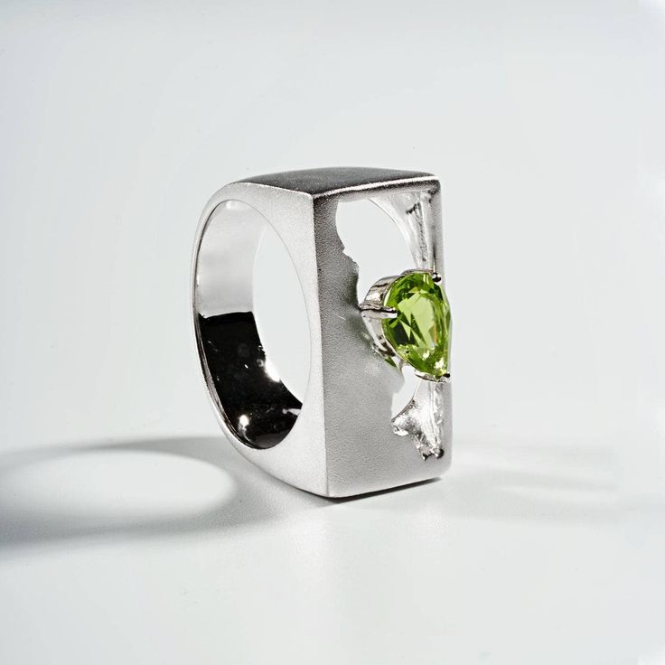 Onoo Peridot Ring, Ring by GERMAN KABIRSKI Modern Peridot Jewelry For Formal Occasions, Silver Peridot Rings With Polished Finish, Modern Peridot Rings For Anniversary, Modern Polished Rings With May Birthstone, Modern Sterling Silver Green Rings, Modern Green Sterling Silver Rings, Modern Green Jewelry For Promise Occasion, Modern Silver Jewelry With Peridot, Modern Silver Peridot Jewelry