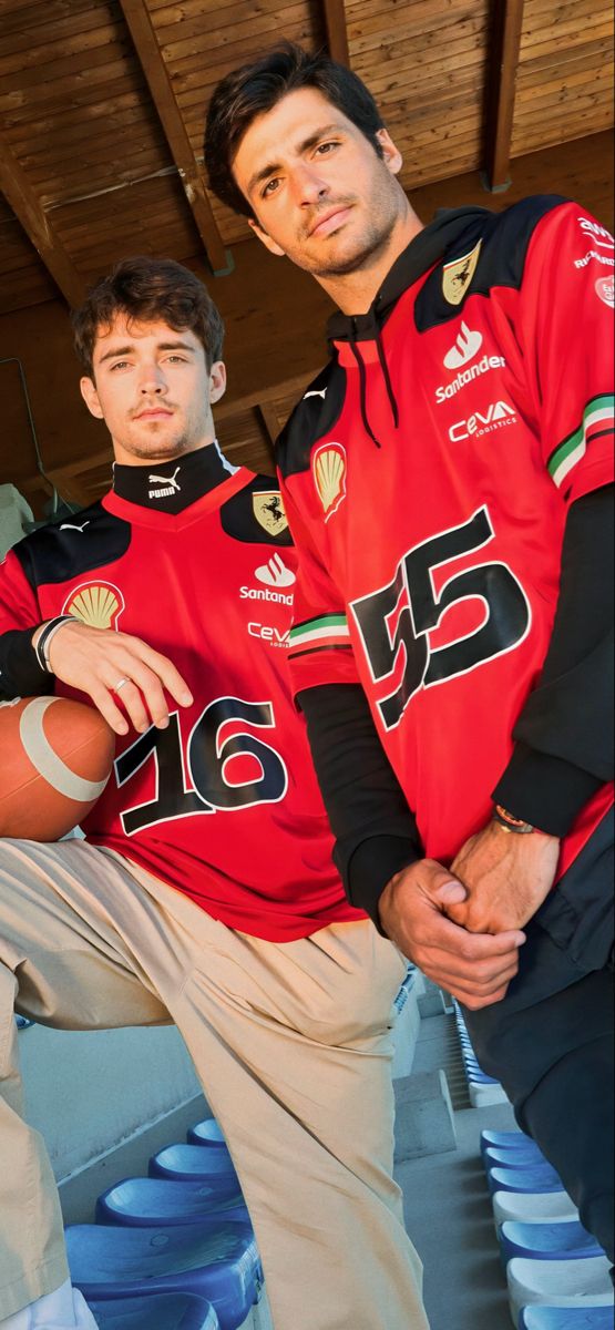 two men in red jerseys posing for the camera with their hands on their hipss