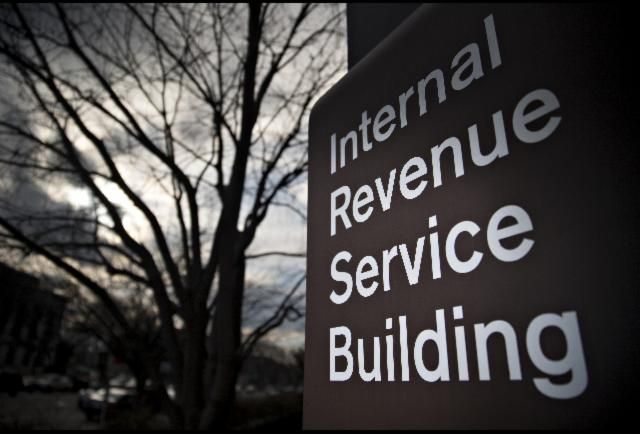 a sign that is in front of a tree with clouds behind it and the words, international avenue service building