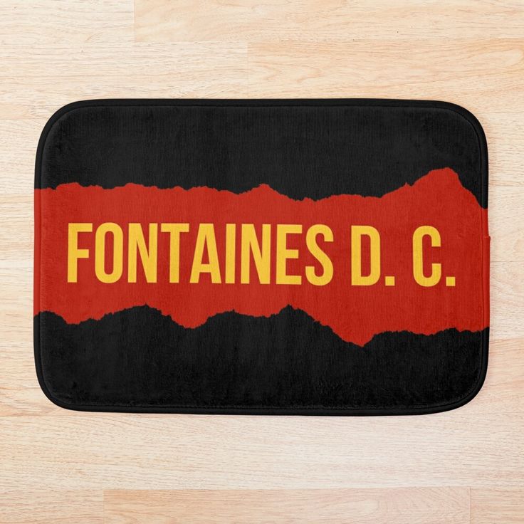 a black and red bath mat with the word fontaines d c printed on it