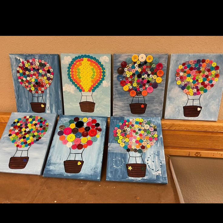 four canvases with hot air balloons painted on them