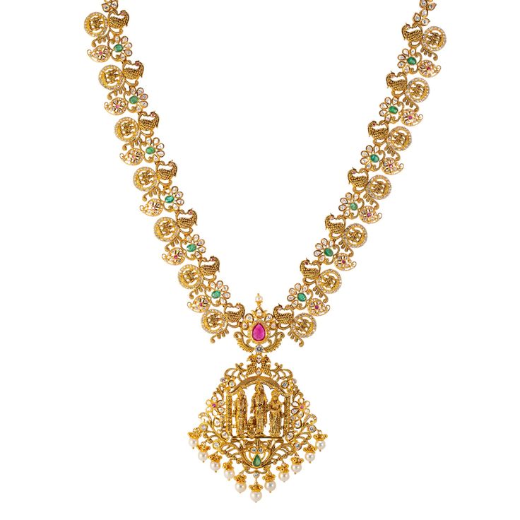 Virani Jewelers invites you to indulge in symphony of cultural elegance with this 22k gold necklace and Jhumki earring set. Meticulously crafted, this Indian gold jewelry set features a captivating mix of gemstones, pearls, and traditional Indian jewelry elements. The warm embrace of 22k gold elevates the temple design, creating a visual masterpiece that resonates with sophistication and cultural heritage. Features • 22k yellow gold • Ruby • Emerald • Cubic zirconia • Pearls Necklace Specificati Festive Chandbali Temple Necklace With Gemstone, Celebration Temple Necklace In 22k Gold With Meenakari, Festive Temple Necklace With 17 Jewels In Chandbali Shape, 22k Gold Meenakari Temple Necklace For Celebrations, Celebration 22k Gold Temple Necklace With Meenakari, Formal Yellow Gold Kundan Necklace For Diwali, Formal Gold Plated Temple Necklace, 22k Gold Tilla Temple Necklace For Celebrations, Festive Temple Necklace With 17 Jewels