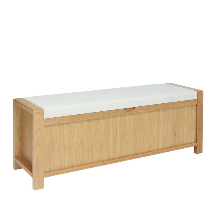 a wooden bench with a white cushion on the top and bottom part of it, against a white background