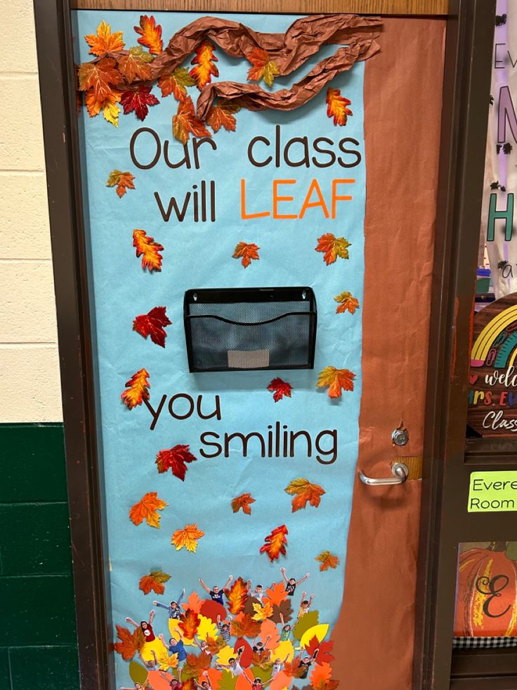 a classroom door decorated with fall leaves and the words our class will leaf you smiling