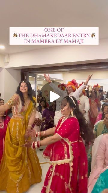 two women in red and yellow sari dancing with other people watching from the sidelines