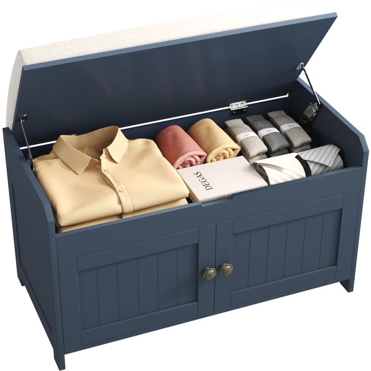 an open chest with folded shirts in it