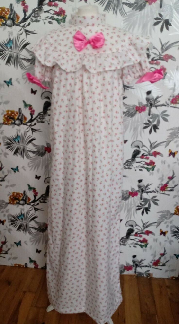 Stunning handmade nightgown, crafted from luxurious 100% Organic Cotton, soft and lightweight. Beautiful pink floral print. Retro vintage style with yoke and ruffle. Puffed sleeves. High Couture French seam which is  neat inside and soft on the skin. Lovely bow trims and ruffle. Measurements: Bust up to 46" Length 58" f Pink Floral Print Nightgown For Home, Short Sleeve Floral Print Nightgown For Home, Floral Print Short Sleeve Dress For Pajama Party, Pink Floral Print Short Sleeve Nightgown, Pink Floral Print Nightgown With Short Sleeves, Pink Ruffled Short Sleeve Sleepwear, Pink Ruffled Nightgown For Sleep, Pink Ruffled Nightgown For Sleepover, Pink Ruffled Nightgown For Pajama Party