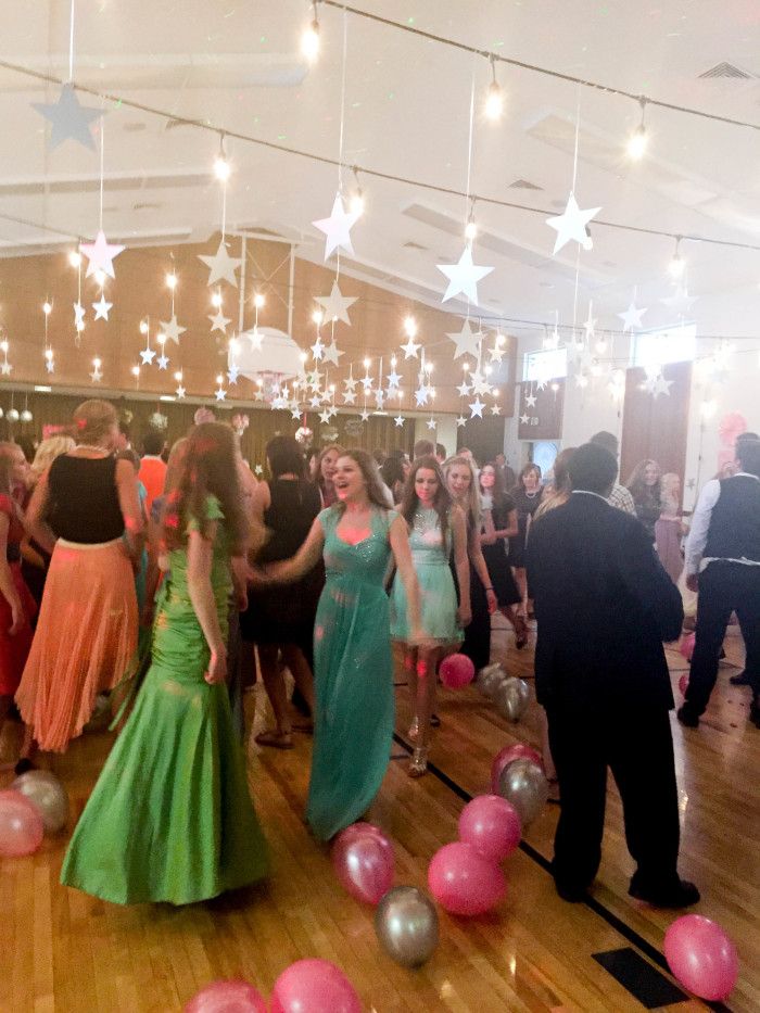 a group of people standing on top of a wooden floor