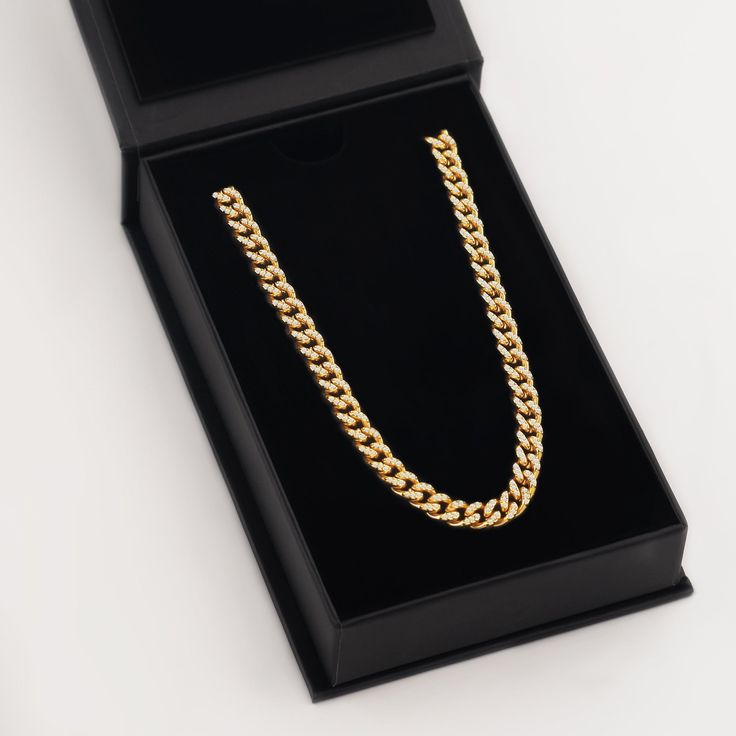 Make a statement with a gold Iced Cuban Link Chain. This chain is the perfect addition to any outfit and you can wear it every single day. Made for: Men (20 inch) & Women (18-20 inch) Thickness: 7mm Premium Gift Box: Included Luxury Cuban Link Gold Chain Necklace Gift, Gold Diamond-cut Cuban Link Necklace Gift, Gold Iced-out Cuban Link Necklace As Gift, Gold Iced-out Cuban Link Chain Necklace, Luxury Gold-plated Cuban Link Necklace, Photo Pendant, Silver Coat, Cuban Link, Cuban Link Chain