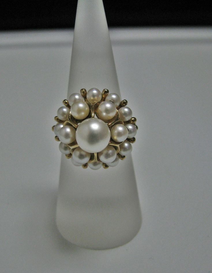 "For Sale is: (1) H077 Stunning Coctail (19) Pearl Ring in 14k Yellow Gold Please Read ENTIRE DESCRIPTION BEFORE PURCHASING This beautiful ring features cocktail ring with multiple (19) pearls in different size. Ring stamped 14k and it is size 5.5 This is a very elegant ring! Cosmetic Condition: This ring is in good condition. A few minor scratches due to age. AS SEEN IN PICTURE: Specifications: *14K Yellow Gold *Cocktail Style *Pearls (12) are approx. 3.4 mm (at the bottom of the ring) *Pearls Classic White Cluster Ring Hallmarked, White Cluster Ring Stamped 14k, Classic White Hallmarked Cluster Ring, Timeless Evening Ring With Prong Setting, Fine Jewelry Yellow Gold Evening Rings, Fine Jewelry Yellow Gold Rings For Evening, Formal White Pearl Ring With Center Stone, Elegant Evening Rings With Center Stone, Formal Brilliant Cut Pearl Ring