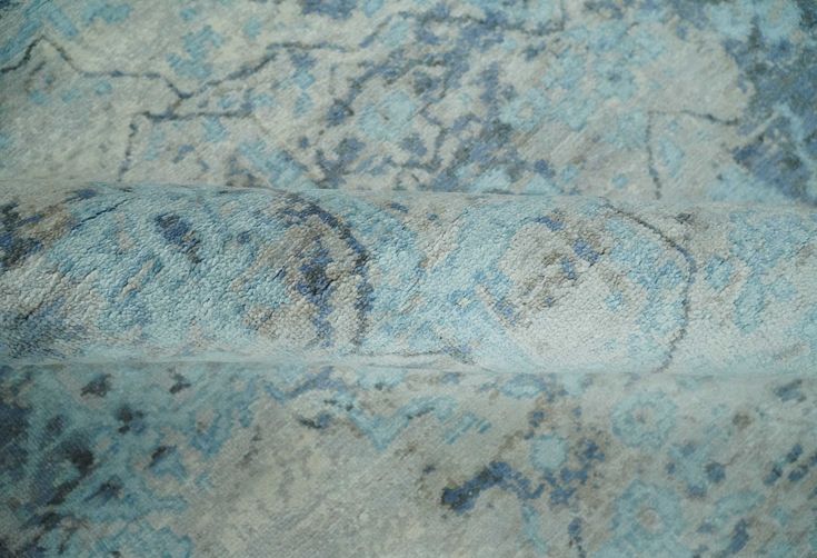 an area rug with blue and gray designs on it is shown in close up view