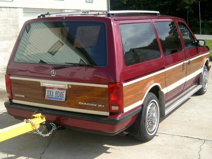 a red van parked in front of a house with a yellow pole attached to it