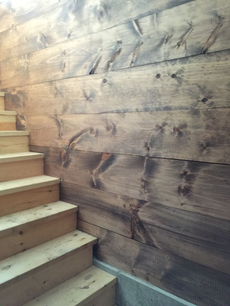 some stairs are next to a wooden wall