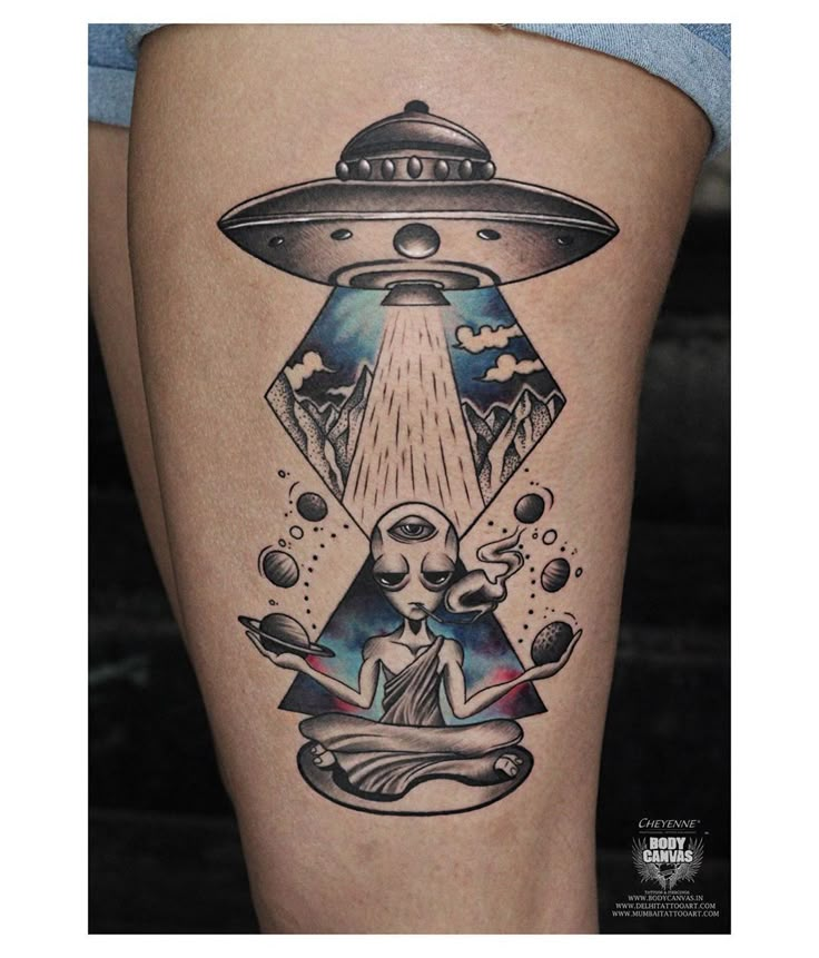 an alien tattoo on the thigh with a woman sitting in front of it and flying through the sky