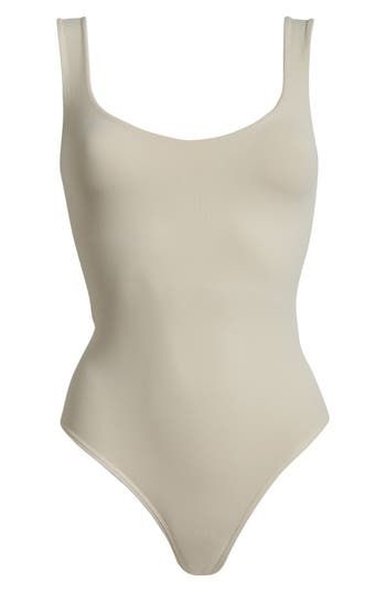 A sleek curve-hugging bodysuit featuring a dipped neckline and low U-back. Stretch fit Built-in shelf bra Snap gusset closure Thong cut 92% nylon, 8% elastane Machine wash, dry flat Imported Elegant High Stretch Leotard With Built-in Bra, Low Back Seamless Bodysuit With Minimal Stretch, Chic Seamless Second-skin Bodysuit, Backless Elastane Bodysuit With Smoothing Details, Seamless Bodysuit With Minimal Stretch And Low Back, Sleek Fitted Bodysuit With Lined Body, Seamless Low Back Bodysuit With Minimal Stretch, Sleek Second-skin One-piece Bodysuit, Stretch Bodysuit With Moderate Back Coverage