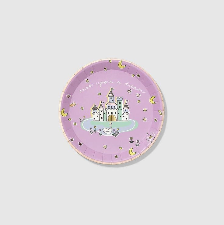 a purple paper plate with a castle on the front and stars in the middle, against a gray background