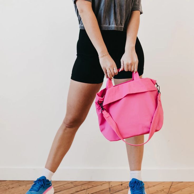 Meet your new BFF - the Carrie Catch All Shoulder Tote Bag! This trendy athleisure bag is perfect for gym days, running errands, or just looking stylish on the go. Comes in multiple colors including black, white, fuchsia, and lilac. Includes a removable strap, inner zipper pocket, and middle divider that also has a zipper pocket for all your essentials. Plus, a latch closure for extra security. The Carrie Catch All Shoulder Tote Bag is another addition to our 3 Sisters Collection! This collectio Pink Nylon Duffle Bag For Everyday Use, Sporty Weekender Bag With Removable Pouch For Everyday, Sporty Pink Weekender Bag For Everyday, Sporty Pink Weekender Bag, Sporty Pink Everyday Travel Bag, Sporty Weekender Tote Bag With Removable Pouch, Sporty Weekender Bag With Removable Pouch, Trendy Pink Weekender Bag For Everyday Use, Functional Pink Travel Bag For Everyday