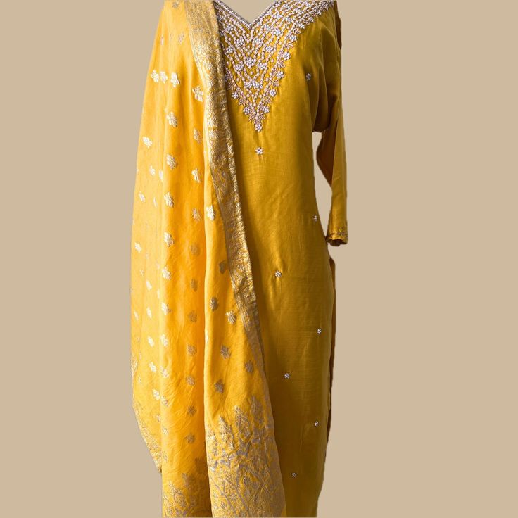 ✨ Shine Bright in Stunning Elegance ✨ Step into the spotlight with our exquisite Yellow Chinnon Silk 3-Piece Suit. Featuring intricate pearl dabka work and a striking brocade dupatta, this ensemble is designed to make you feel like royalty on any special occasion. 🌸 Key Features: *Material: Luxurious Chinnon Silk *Design: Intricate Pearl Dabka Work *Dupatta: Eye-Catching Brocade Dupatta *Suit Set: Includes Kurta, Palazzo Pants, and Dupatta *Color: Radiant Yellow *Care Instructions: Dry Clean On Yellow Self-design Palazzo Set For Wedding, Fitted Gold Chanderi Sets, Fitted Yellow Sets For Celebration, Yellow Fitted Sets For Celebration, Celebration Silk Sets In Gold, Silk Gold Sets For Celebration, Gold Silk Sets For Celebration, Elegant Yellow Sets For Celebration, Elegant Yellow Festive Sets