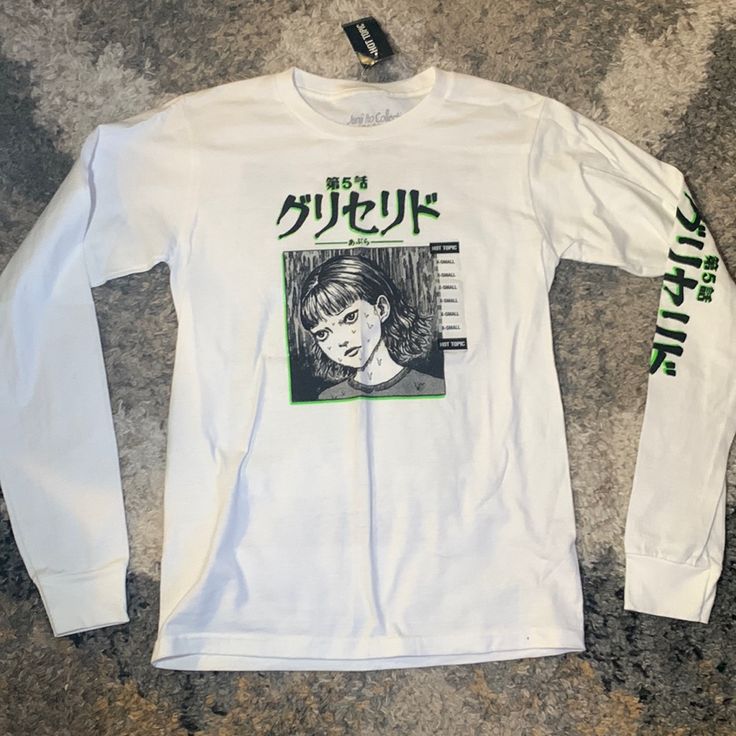 a white long - sleeved shirt with green writing on the front and back, featuring an image of a woman's face