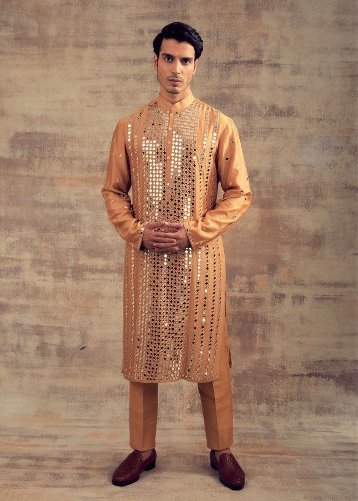 Featuring this Gold Beige color kurta set with mirror embroidery. This set has glass mirrors covered with Resham by hand embroidery. Perfect fit for Haldi or sangeet functions. Brand: Panache Haute Couture Availability: Online and In-store Delivery Time: 4-6 Weeks Fabric: Kurta and Bottom - Raw Silk Customisation: For more colour options please contact our team through WhatsApp+61470219564 Disclaimer: The model is of Size 40 and is 5 feet 10 inches tall and the model is wearing raw silk bottom o Embroidery Kurta, Mirror Embroidery, Color Mirror, Glass Mirrors, Silk Bottoms, Men's Outfits, Indian Man, Kurta Set, Raw Silk