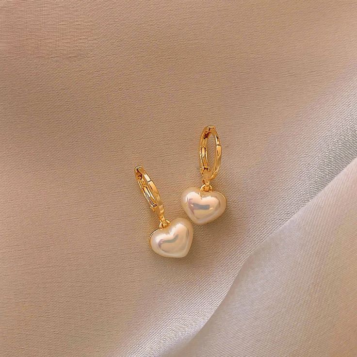 "Freshwater Pearl Drop Earrings, Simple Gold Huggie Pearl Earrings, Bridal Earrings Pearl, Minimalist Pearl Earrings, Gift For Her These dainty earrings, crafted with care, feature genuine pearls shaped into adorable hearts.  The natural sheen of the pearls adds sophistication, making them a charming accessory for any occasion. Perfect for dressing up or adding a touch of glamour to your everyday look, these earrings are lightweight and comfortable.  Gift them to someone special or treat yourself to a timeless piece that symbolizes love and connection.  Order now and add a touch of heartfelt beauty to your collection! Details * Material: Gold / Freshwater Pearl * Best christmas gift, birthday gift for family, friends and yourself How To Order: * Click either \"Buy it now\" or \"Add to cart Aliexpress Finds, Earrings 2023, Pearl Pendant Earrings, Womens Earrings, Pearl Heart, Jewelry Accessories Ideas, Bridal Earrings Pearl, Jewelry Essentials, Classy Jewelry