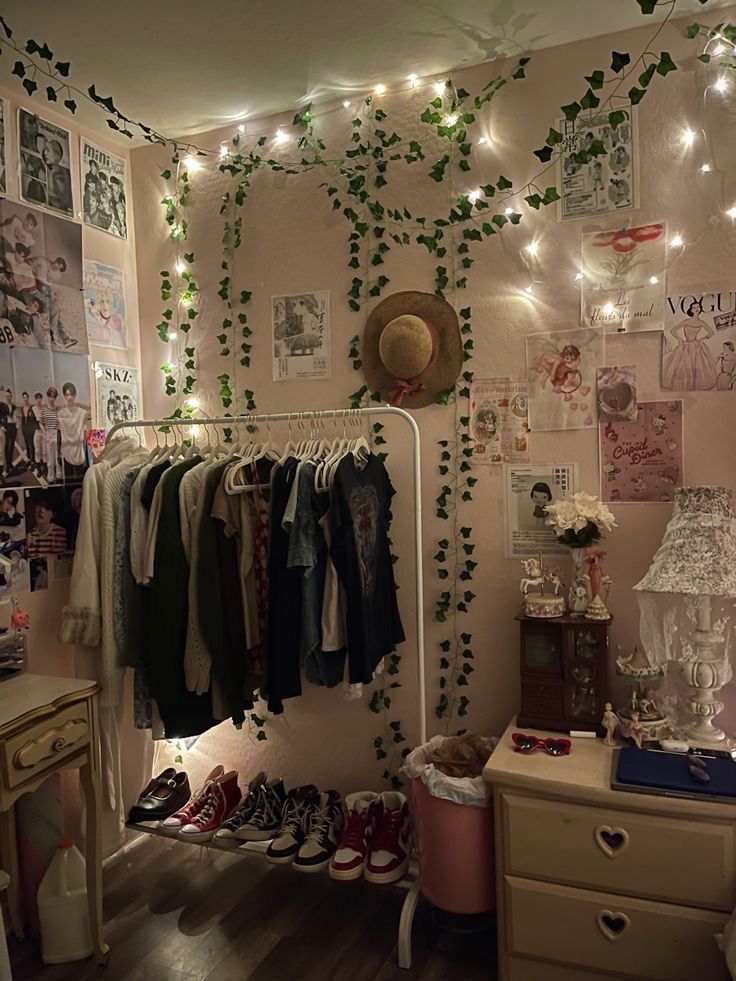 a bedroom with lots of clothes hanging on the wall and lights strung from the ceiling