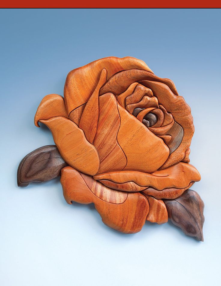 a carved wooden rose sitting on top of a table