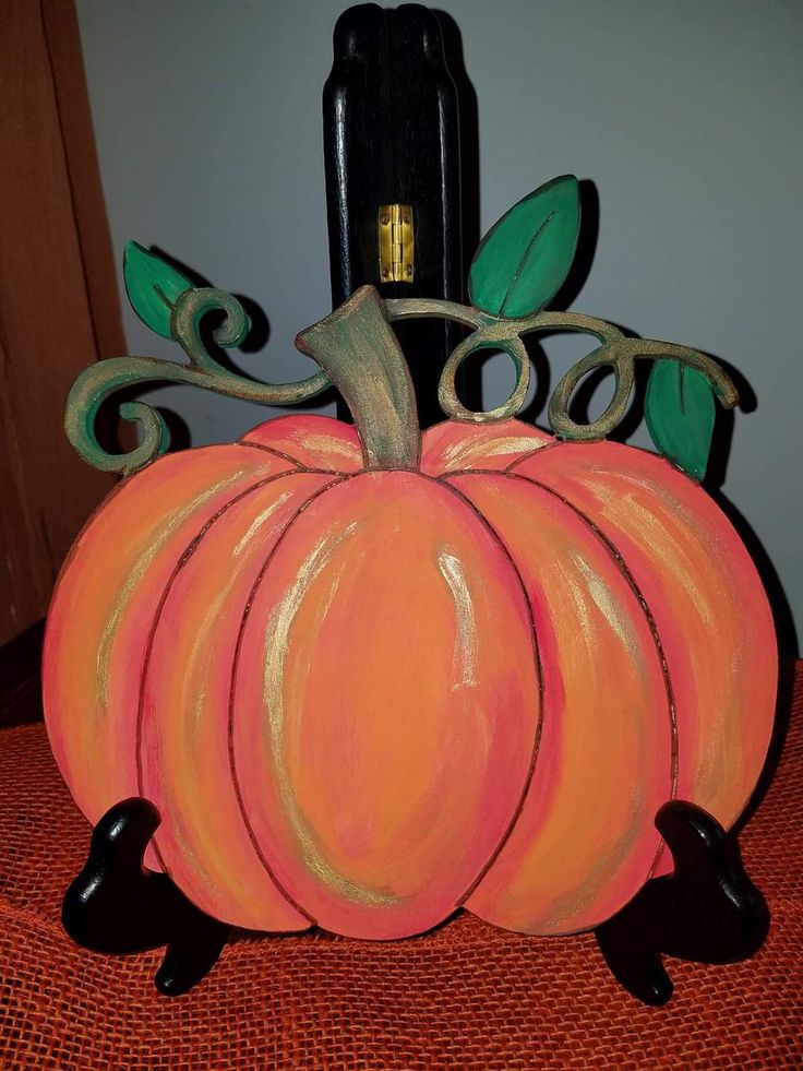 a painted pumpkin sitting on top of a table