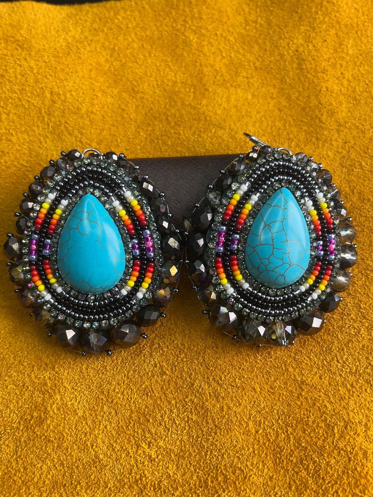 Handmade beaded earrings with hide backing and lever hooks (hooks can be changed upon request). Artisan Beaded Earrings, Artisan Beaded Drop Earrings With Large Beads, Artisan Large Beaded Drop Earrings, Festival Teardrop Beaded Earrings With Large Beads, Teardrop Beaded Earrings With Large Beads For Festivals, Artisan Large Beads Drop Earrings, Teardrop Large Beaded Earrings For Festivals, Artisan Colorful Beaded Teardrop Earrings, Beaded Bohemian Clip-on Earrings