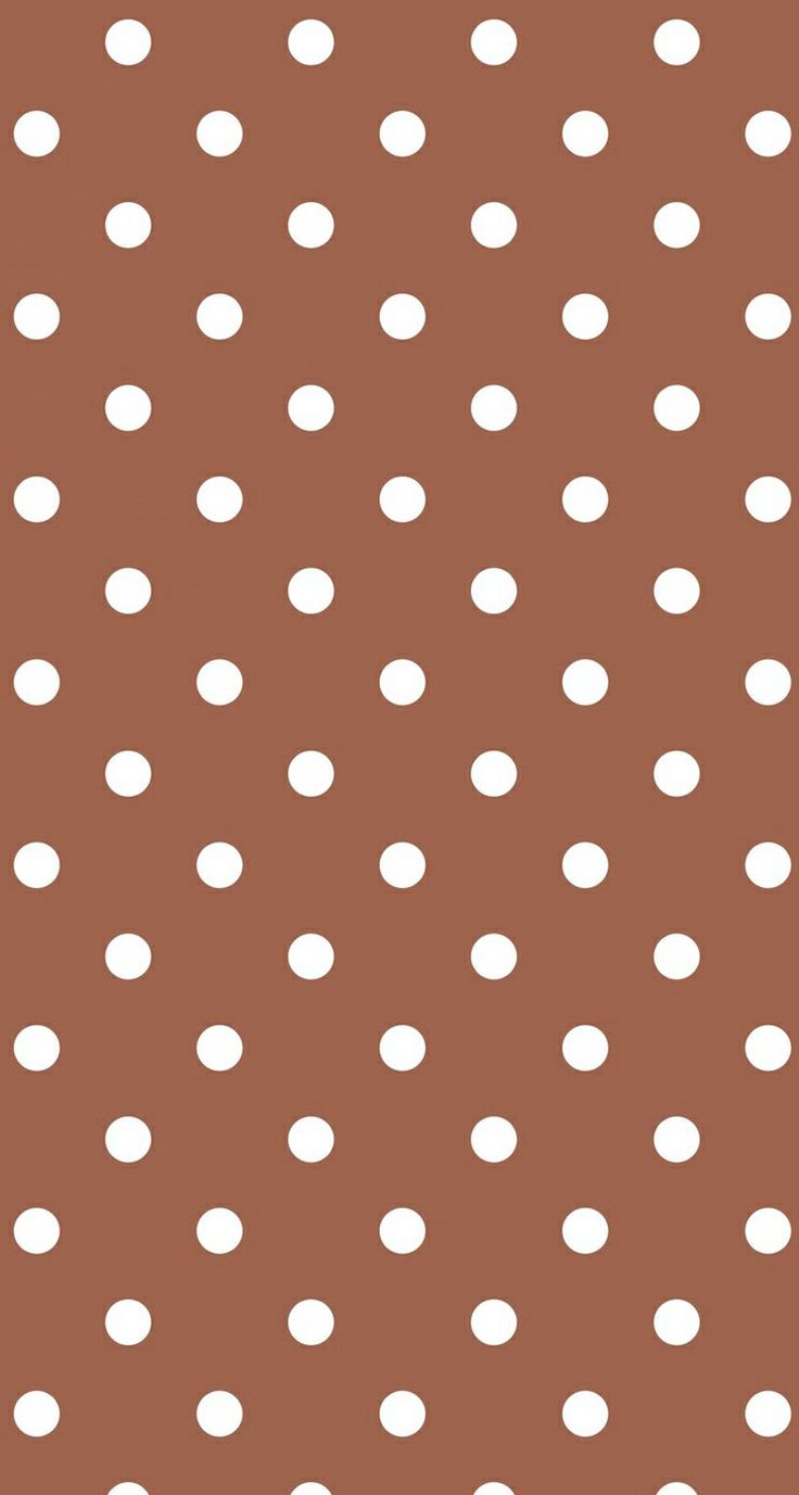 a brown background with white polka dots