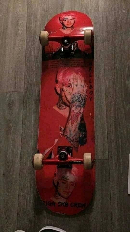 a red skateboard sitting on top of a wooden floor