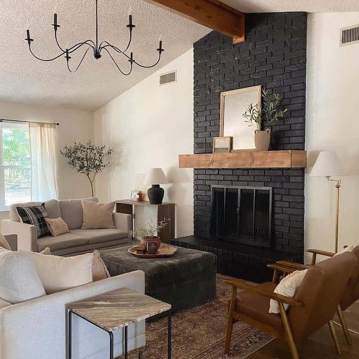 a living room filled with furniture and a fire place in front of a brick fireplace