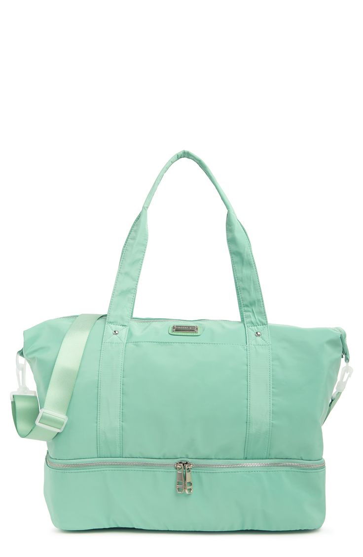 Stay stylish when traveling. The roomy interior of this Madden Girl weekend bag fits some of your favorite outfits and toiletries. - Dual top handles- Detachable, adjustable shoulder strap- Top zip closure- Exterior features slip pockets and bottom zip pocket- Interior features media pockets and zip wall pocket- Approx. 11" H x 19" W x 9.5" D- Approx. 12" handle drop, 19-30" strap drop - Imported Textile exterior and lining Green Shoulder Duffle Bag For Travel, Green Large Capacity Tote Gym Bag, Weekender Tote Bag With Adjustable Handle For Travel, Sporty Bags With Adjustable Strap For Weekend Trips, Sporty Bag With Adjustable Strap For Weekend Trips, Adjustable Handle Tote Weekender Bag For Travel, Travel Weekender Tote With Adjustable Handle, Travel Weekender Bag With Adjustable Handle, Green Duffle Bag For On-the-go