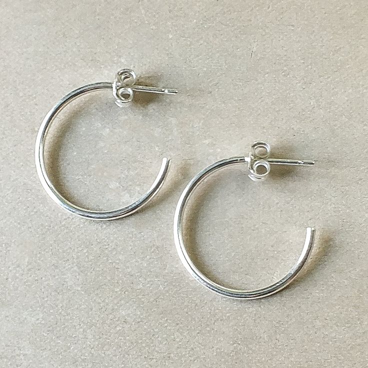 Simple and classic. Lightweight, dainty hoops to wear anywhere and everywhere. Simple Everyday Hoop Huggie Earrings, Adjustable Classic Hoop Earrings, Classic Adjustable Hoop Earrings For Pierced Ears, Classic Small Hoop Jewelry For Everyday, Simple Small Hoop Everyday Jewelry, Classic Adjustable Hoop Earrings, Classic Round Hoop Earrings For Everyday, Classic Adjustable Hoop Earrings For Everyday, Adjustable Classic Hoop Earrings In Sterling Silver