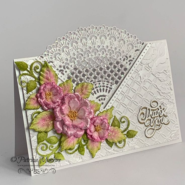 a white card with pink flowers on it