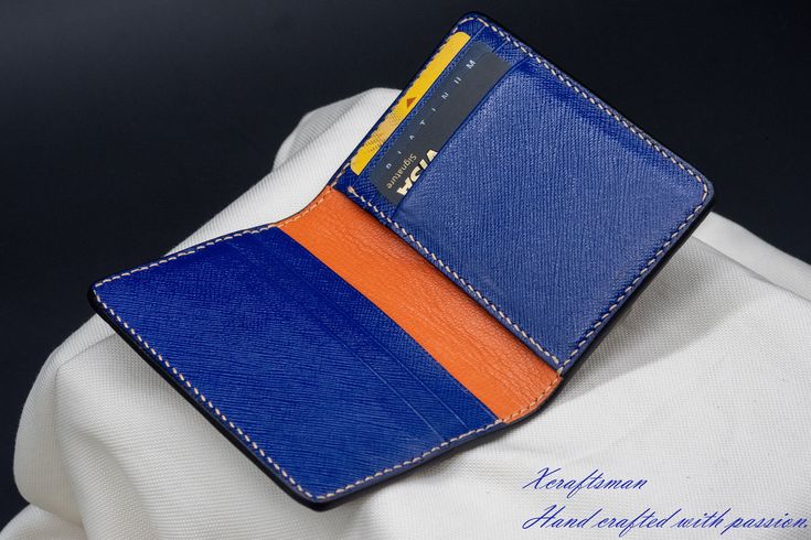 This wallet is unique, you will never see the exact same thing. The exterior alligator leather is cut along its scale's edge to show an orange layer below. The orange line is unique because the texture of the alligator is unique. The wallet opens vibrantly with blue and orange color inside. I've tried my best to put my unique technique and my passion into this small piece. Every single wallet is made to order, there won't be a second same thing. If you are looking for a small accessory but it's Luxury Blue Card Holder As Gift, Luxury Blue Card Holder For Gift, Luxury Blue Card Holder Gift, Luxury Blue Wallets As Gift, Blue Bifold Card Holder For Formal Occasions, Luxury Blue Leather Card Holder, Blue Business Card Holder With Interior Slots, Business Blue Card Holder With Interior Slots, Formal Blue Bifold Card Holder