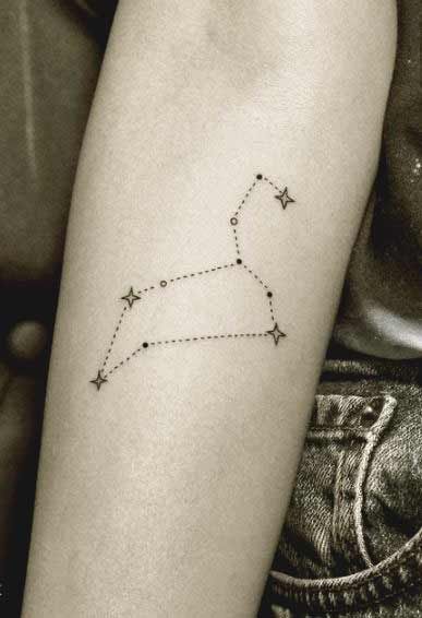 a woman's arm with a small star tattoo on it